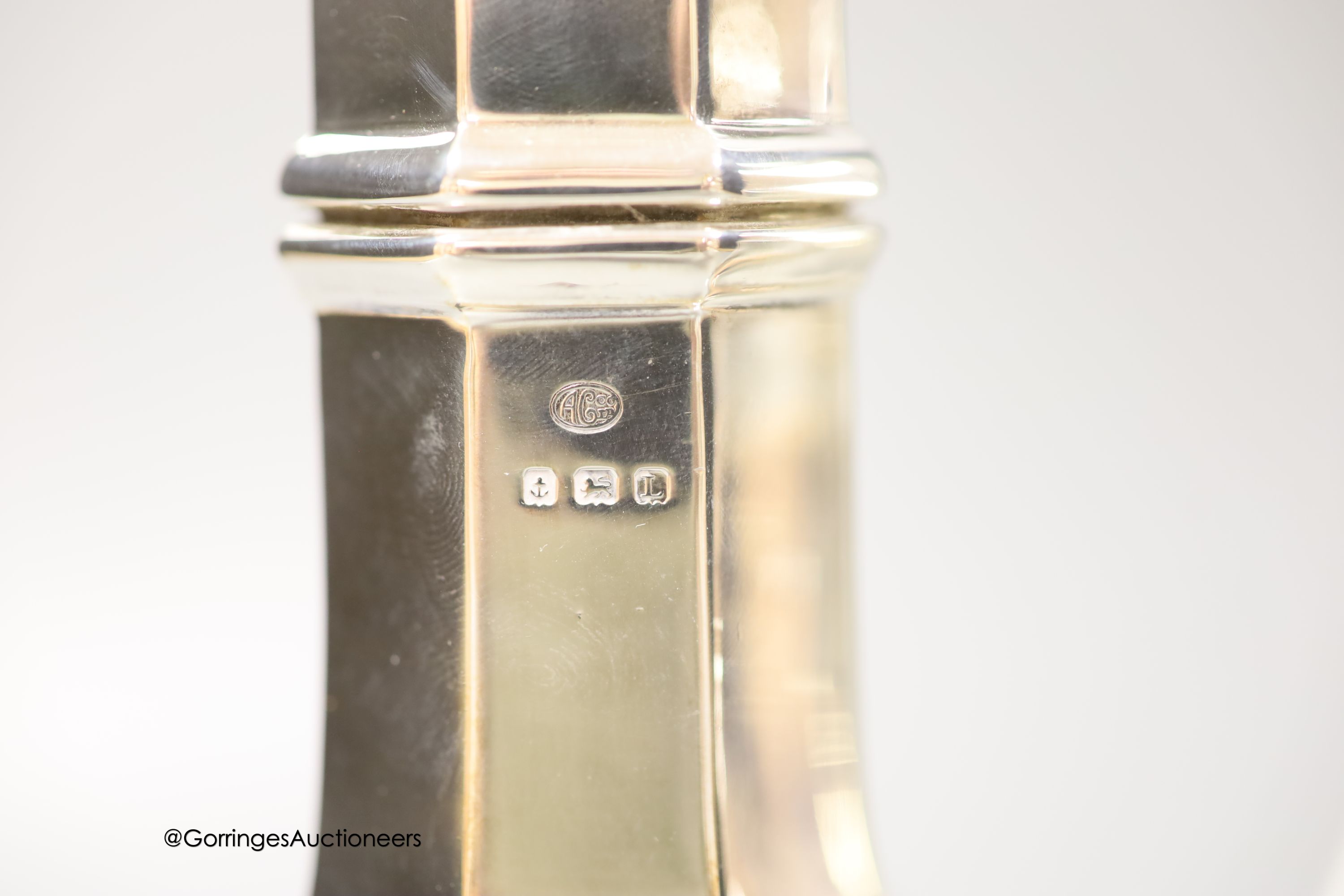A George V silver panelled sugar caster, Birmingham, 1935, 22.3cm and a smaller earlier silver sugar caster